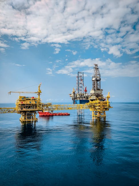 A vibrant offshore oil rig under a clear sky, reflecting in the calm blue sea.